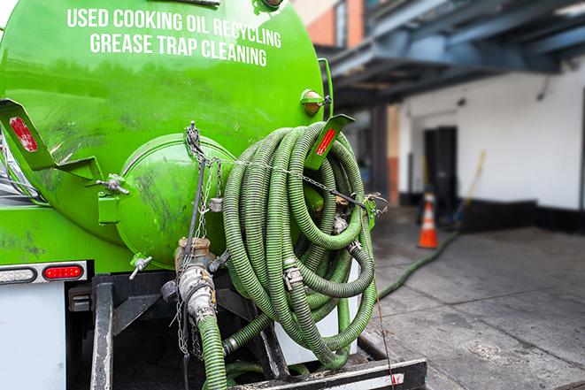 technicians pumping out a commercial grease trap in Bowmansville, NY